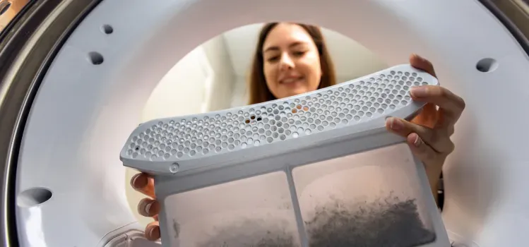 woman-cleaning-dryer-lint-trap-top-view